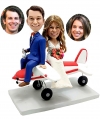 Custom bobble heads on airplane travelling themed wedding
